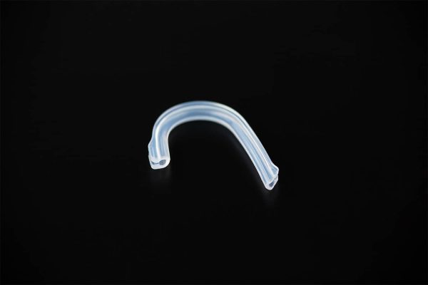 A clear plastic hook highlighting Final Audio - F4100 - Stereo Earphones on a black surface.
