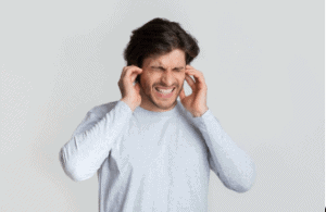 Man grimacing from pain in his ears