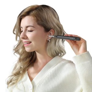 Woman shown inserting an EAR/BeBird X1 otoscope in her ear canal.